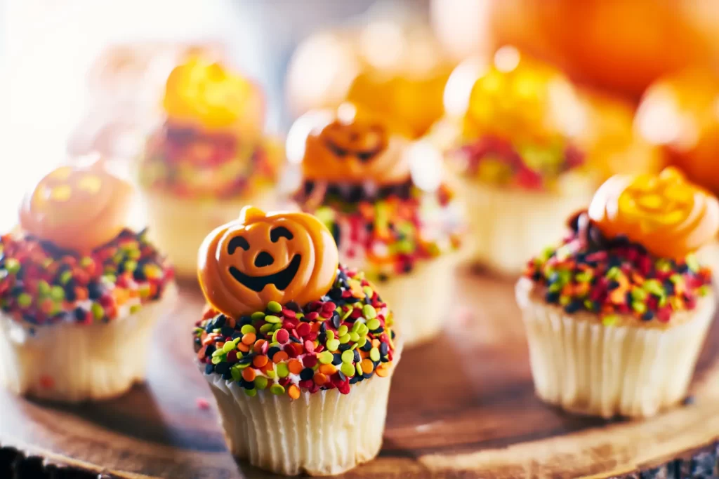 cupcakes festifs a la citrouille dhalloween avec glacage au chocolat et paillettes colorees